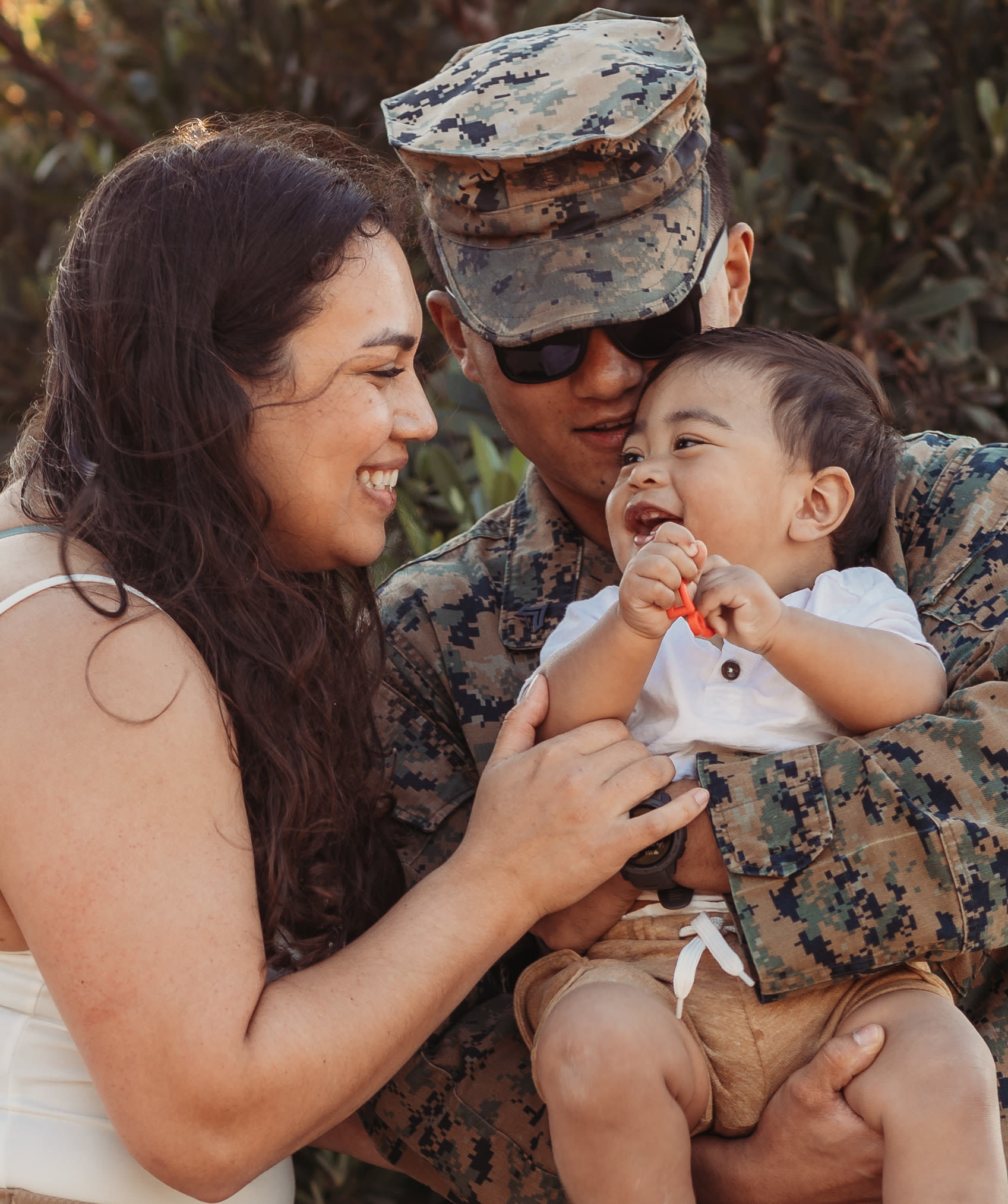 family of a woman, military member and baby